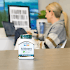 A bottle of 21st Century Echinacea 250 mg Complex vegetarian capsules with a woman in the background working on a laptop.