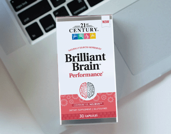 A box of 21st Century's Brilliant Brain sitting on a crossword puzzle.