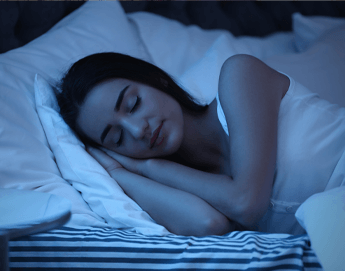 Girl sleeping in bed in dark room