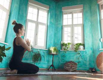 Girl doing a yoga pose in her living room.