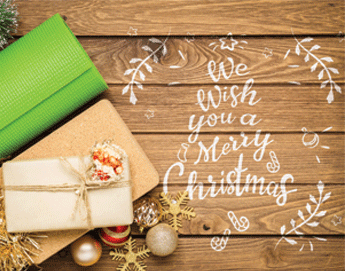 Wrapped gifts, a yoga mat and Christmas bulbs next to the holiday greeting, We Wish You a Merry Christmas.