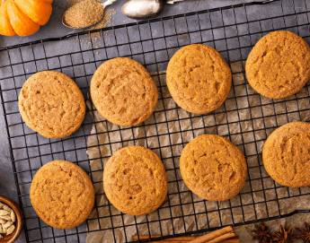 Pumpkin cookies on a cooling rack.