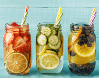 Mason jars filled with assorted fruits floating in water.