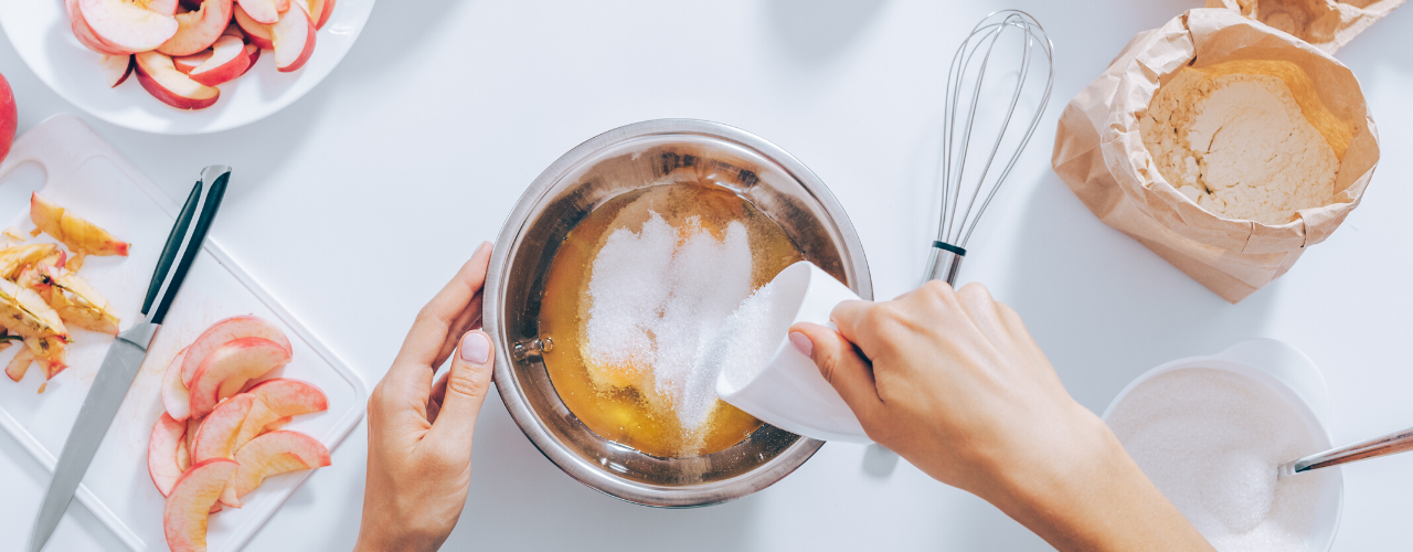 A top view of prepping and mixing ingredients to make apple pie.