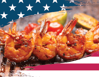 Delicious looking shrimp skewers on a grill top.