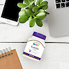 A bottle of 21st Century Lutein 20 mg softgels laying on a desk with a note pad, tablet, laptop and succulent plant.