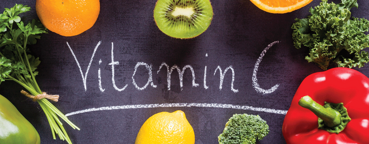 A top view of oranges, kiwi, tomato, broccoli, lemon, and red pepper next to text that says Vitamin C.